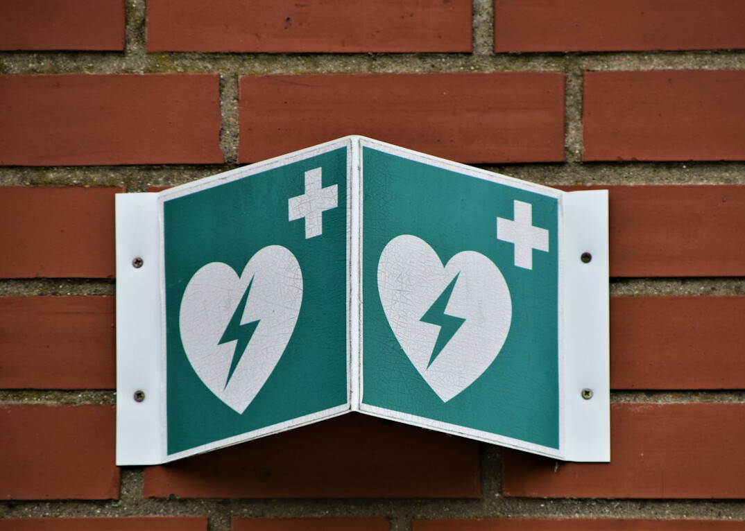 Automated external defibrillator mounted on a wall