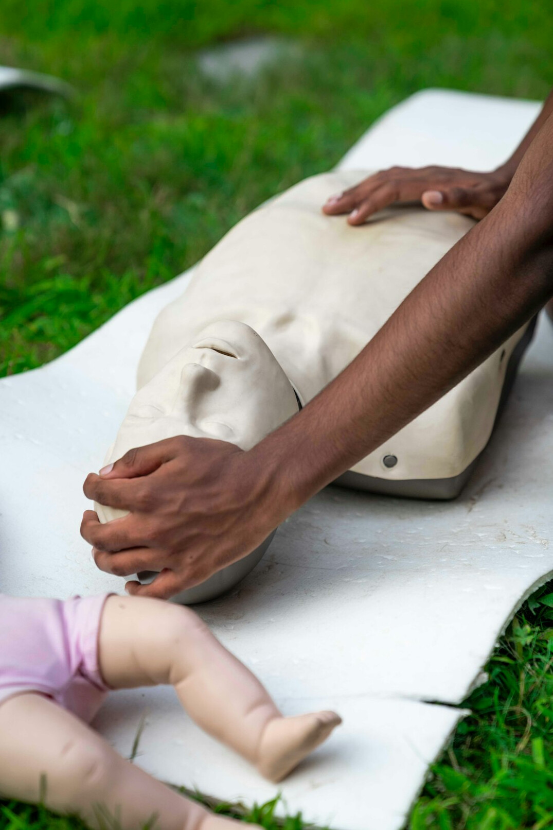 Healthcare workers practicing CPR on a training manikin